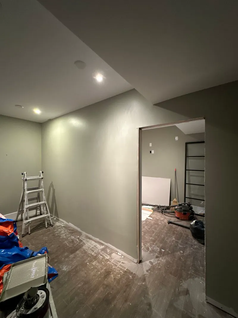 Room mid-renovation with tools and materials on the floor
